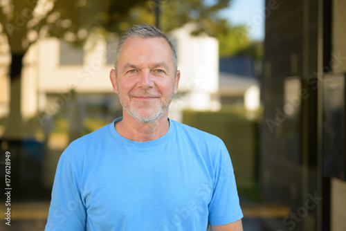 Mature man smiling outside confidently