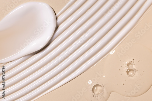 samples of cosmetic care products smear of cream gel texture on a beige background