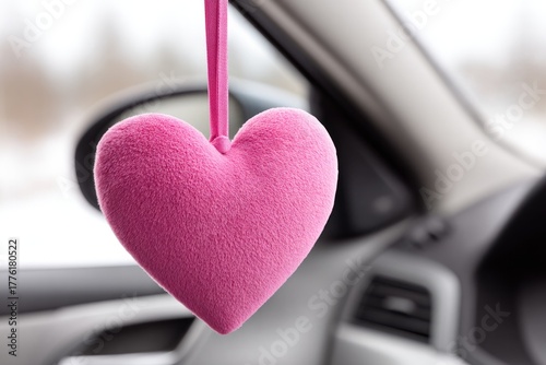 Heart shaped air freshener for valentines day hanging on car mirror with soft pink texture