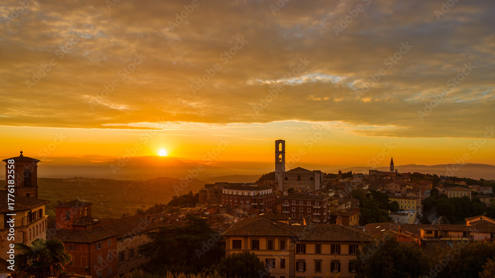 Beautiful dawn sky with morning haze over the old city of Perugia, with medieval bell towers and Umbria countryside in the background