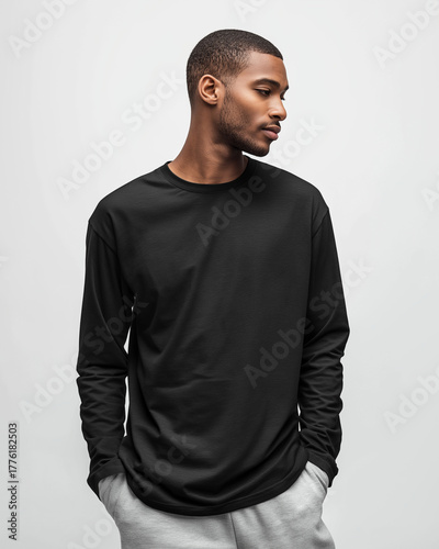 side profile view of model wearing black long sleeve t-shirt, full-body, clean white seamless background