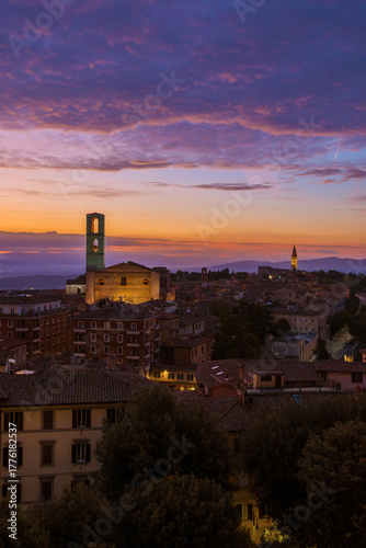 Beautiful purple clouds over Perugia historical center just before dawn