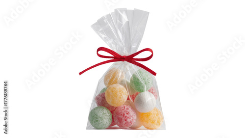 A clear cellophane bag holds an assortment of colorful, sugar-coated round candies, tied with a festive red ribbon. background removed