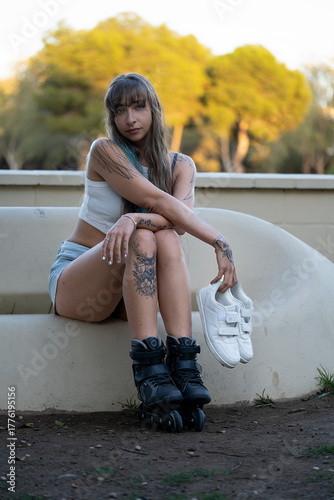 Young woman resting outdoors with roller skates and casual shoes