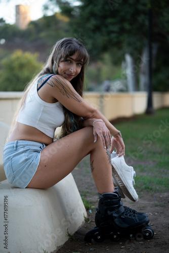 Woman resting after rollerblading in park