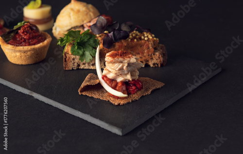 Gourmet platter of assorted creative appetizers on slate