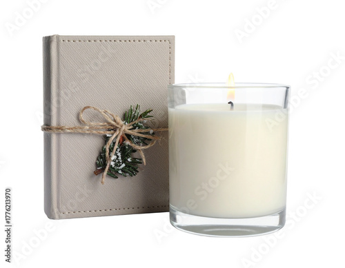 Minimalist Burning Candle and Winter Book on White Surface