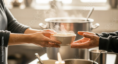 Close up volunteer hands giving warm food bowl to needy person in charity kitchen community support human kindness social care helping hands humanitarian aid soup distribution service soft light 