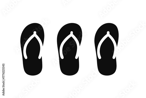 Simple black flip flops arranged in a row for summer fashion and beach outings