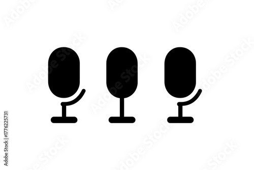 Three microphones on stands ready for recording an audio session in a studio environment