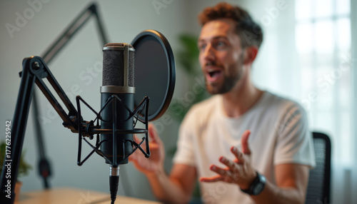 Man speaks at microphone for online show. Guy records podcast broadcasts. Broadcaster presents news. Speaker performs live stream in studio. Vocal performance in sound recording. Content creator