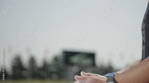 Female hands of a professional athlete shake off white sports powder
