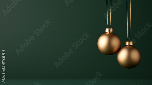 Two elegant golden Christmas ornaments hang against a deep green backdrop, embodying festive sophistication and classic holiday charm. Simple, yet striking, seasonal decor.