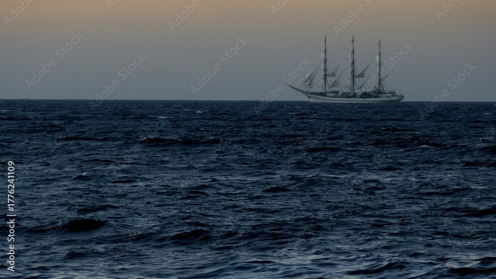 Fototapeta premium beautiful old sailboat in the evening sea