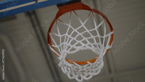 Bottom view of basketball hoop without ball, filmed in motion