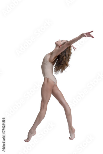 ballerina with beautiful feet poses in a photo studio, a ballerina in a leopard walks with her arms up