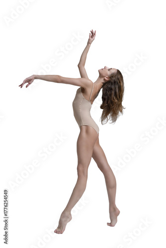 ballerina with beautiful feet poses in a photo studio, a ballerina in a leopard walks with her arms up