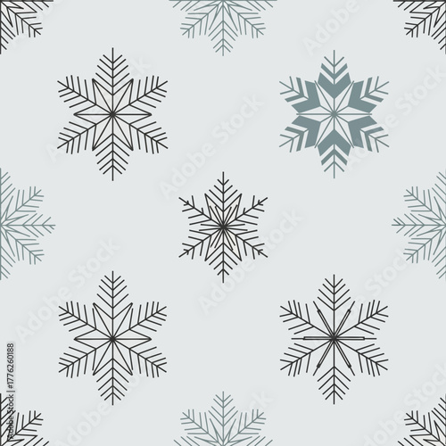 Seamless pattern of snowflakes in various shades of gray, creating a wintery background.