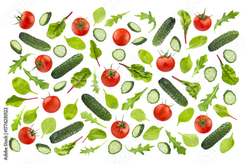 Set of fresh vegetables, leafy greens as ingredients for salad, art pattern, isolated. Cucumbers sliced, cherry tomato, lush green spinach, arugula leaves. Ideal for organic cuisine, healthy eating.