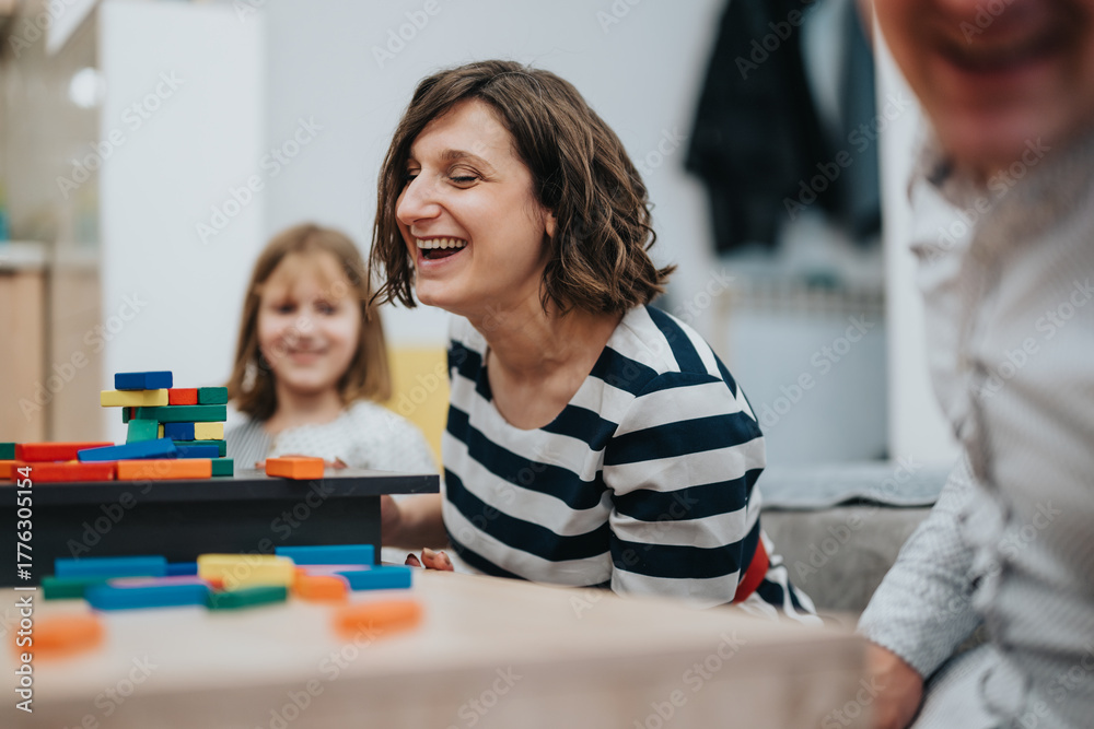 Fototapeta premium A family spending joyful moments together at home, playing and sharing laughter with colorful blocks, symbolizing love, bonding, and togetherness.