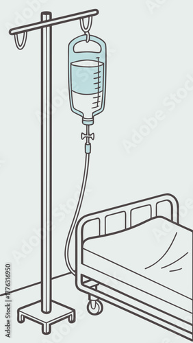 Saline drip bag hanging on stand beside empty hospital bed  