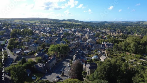 Scenic high aerial view of the town of Alnwick in Northumberland showing the town streets and buildings surrounded by countryside