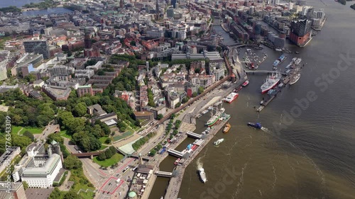 Aerial footage of bustling port of Hamburg, with boats navigating Elbe river and iconic Elbphilharmonie modern building
