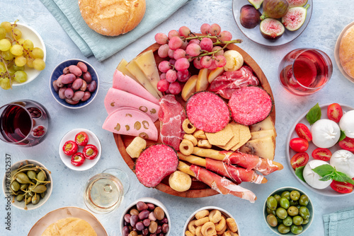 Italian Antipasti. Charcuterie platter with cheese and other snacks, with wine, overhead flat lay shot