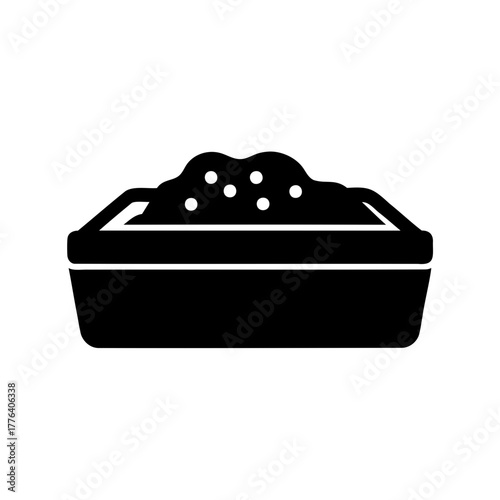 Black silhouette of a baking pan filled with dough ready to bake