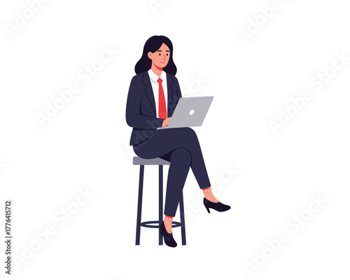 Professional businesswoman in a dark suit and red tie sitting on a high stool working on a laptop computer