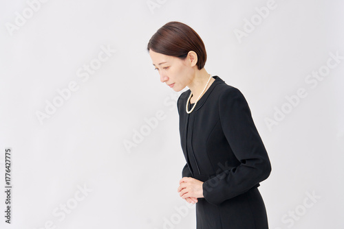 喪服を着た女性　お辞儀　白背景　左向き