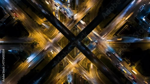Aerial view of city intersection illuminated at night with traffic  