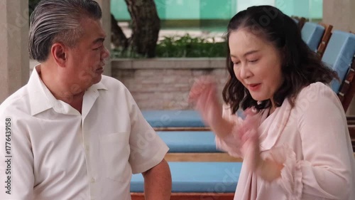 Angry Asian Senior couple having argument and conflict with bad mood, staring at each other