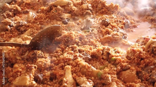 Preparing a huge paella over the weekend for a group of friends. Adding the stock