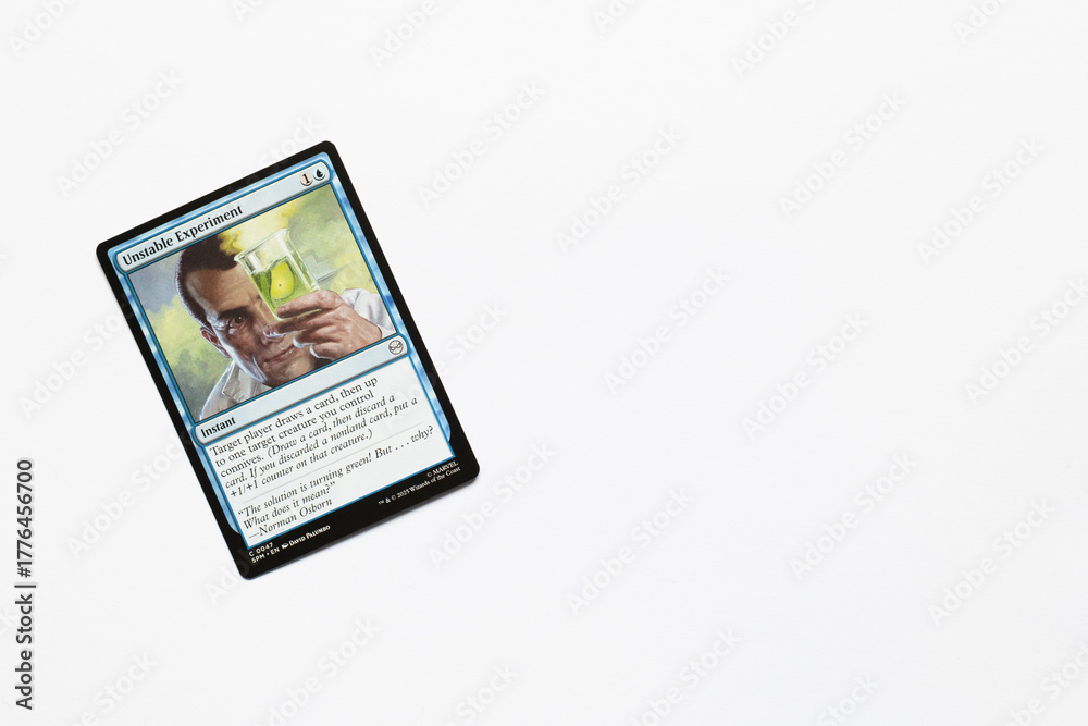 Obraz premium Bradford, UK Nov 3 2025 Unstable Experiment card from the Spider-man magic the gathering card game shot isolated on a white paper background.
