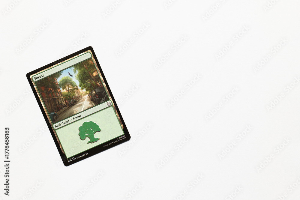 Obraz premium Bradford, UK Nov 3 2025 Forest basic land card from Spider-man magic the gathering game shot isolated on a white paper background.