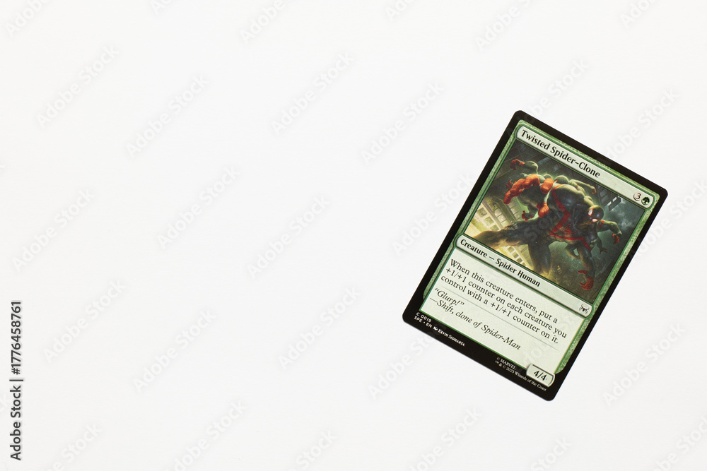 Obraz premium Bradford, UK Nov 3 2025 Twisted Spider-clone card from Spider-man magic the gathering game shot isolated on a white paper background.