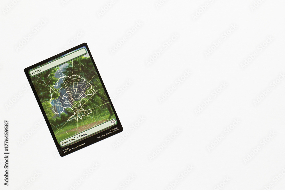 Obraz premium Bradford, UK Nov 3 2025 Forest, basic land card from Spider-man magic the gathering card game shot isolated on a white paper background.