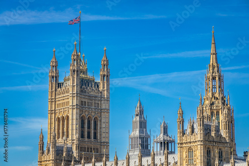Palace of Westminster, with the Victoria Tower at left and the central spire of the building at the tight in London, UK