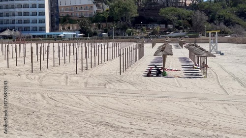 End of season / beginning of season, beach umbrellas are being set up / taken down on the beach, Santa Ponsa, Calvia, Mallorca