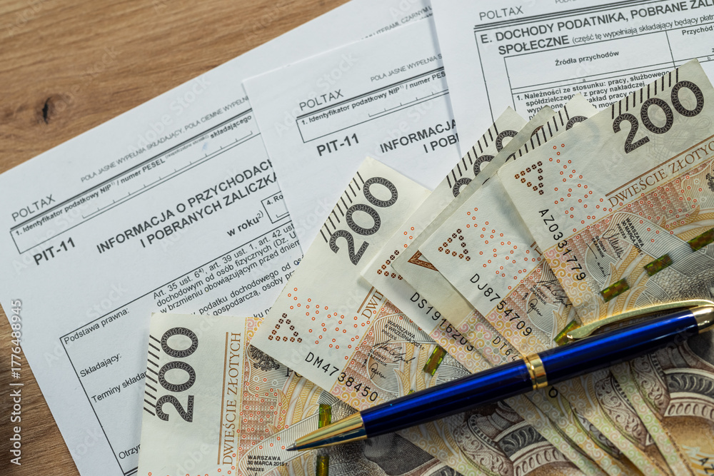 Obraz premium Polish PIT-11 tax form with 200 zloty banknotes, personal income tax and finance concept in Poland