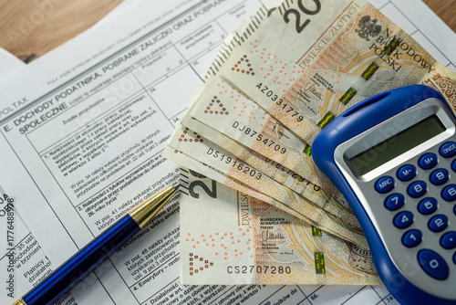 Fotografía Polish PIT-11 tax declaration with 200 zloty and blue calculator, financial plan
