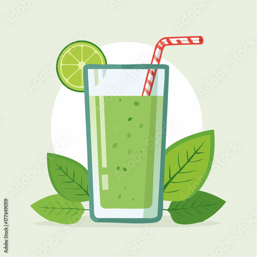 Tall glass of green smoothie with striped straw and lime slice garnish surrounded by fresh green leaves