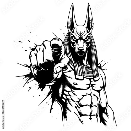 The Egyptian god Anubis, depicted with a jackal head and muscular body, points forward with an aggressive expression in a black and white ink splatter style