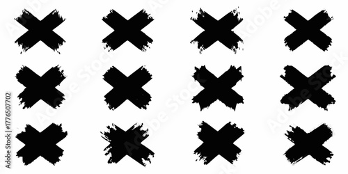 Collection of twelve black abstract brush stroke x marks on a white background