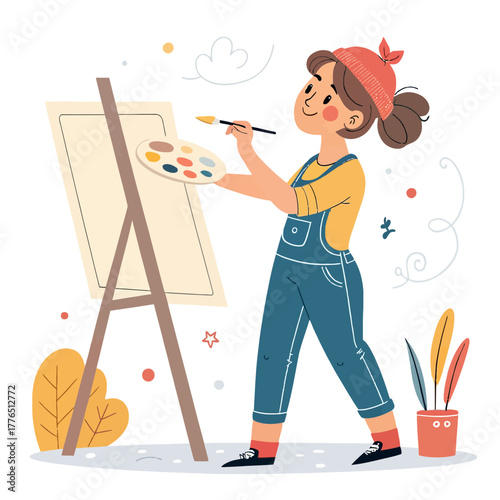 A happy young artist creating art on canvas in a studio