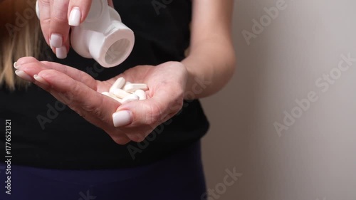 Close-up of woman pouring pills into hand, symbolizing emotional breakdown, depression, or mental health struggle. Concept of despair, loneliness, and psychological pain.