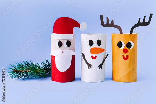 Christmas toy from toilet tube roll, paper toy santa claus, snowman, reindeer, tree rabbit on yellow background. Holiday easy kids DIY, decoration idea for winter season, home party. Children's crafts
