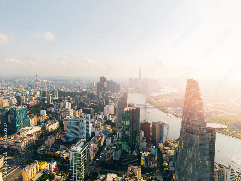 Obraz premium Ho Chi Minh City skyline and skyscrapers on Saigon river Aerial view with sunlight. Financial business center at downtown sunset time.