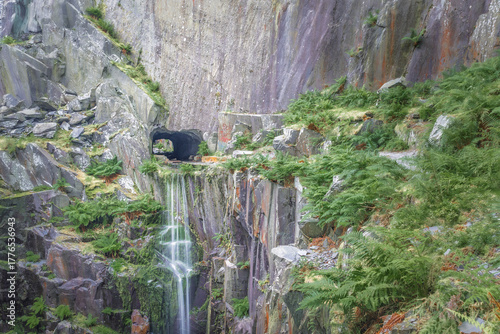 Beautiful waterfall flowing from quarry face at Dinorwic Quarry North Wales landscape